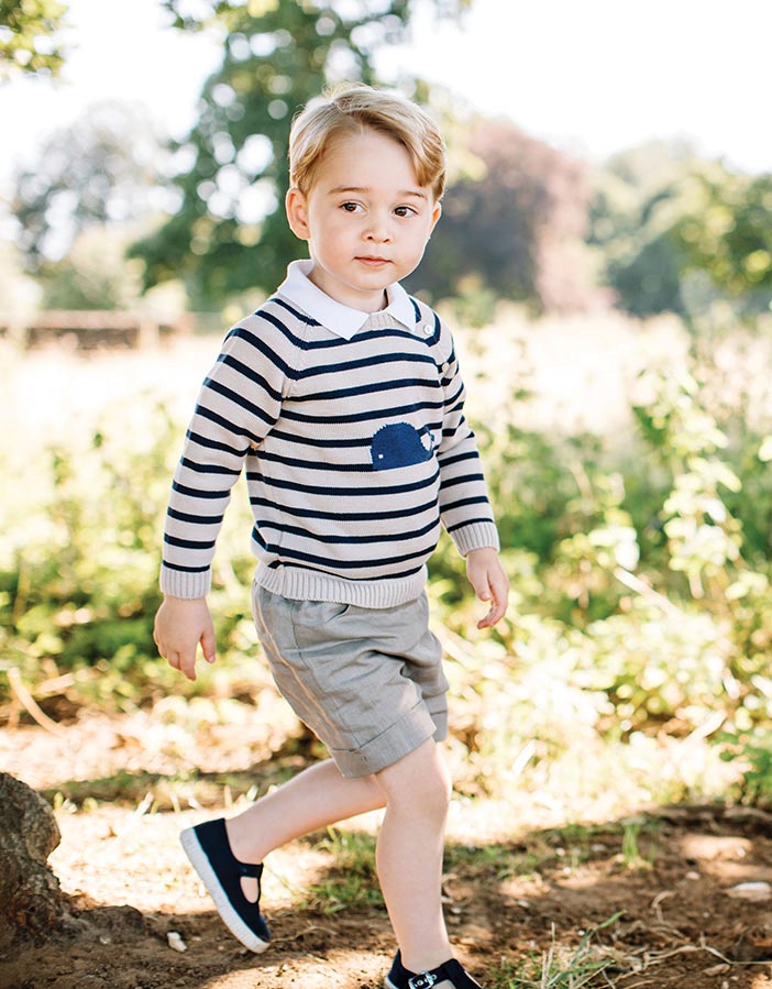 Prince George enjoyed having his third birthday photographs taken at Anmer Hall, Norfolk. (Above) Prince George with the family dog Lupo.