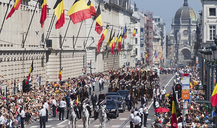 King Philippe and Queen Mathilde, second car from left, ride in a parade during the celebrations in Brussels.  